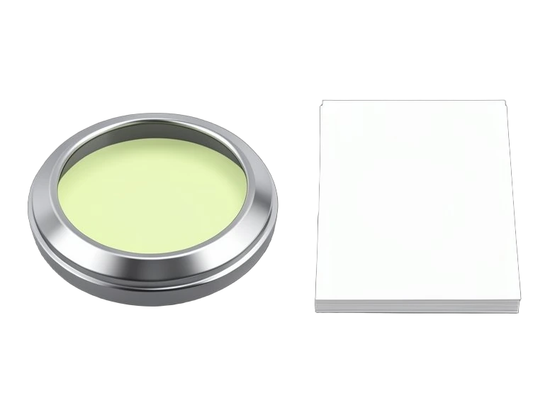 A heavy round metal paperweight pinning a neat stack of blank sheets; one identical blank sheet stands apart beside the stack.