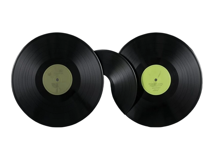 Two solid vinyl records standing face to face, a third record sliding between them so its grooves merge both discs into one combined track.